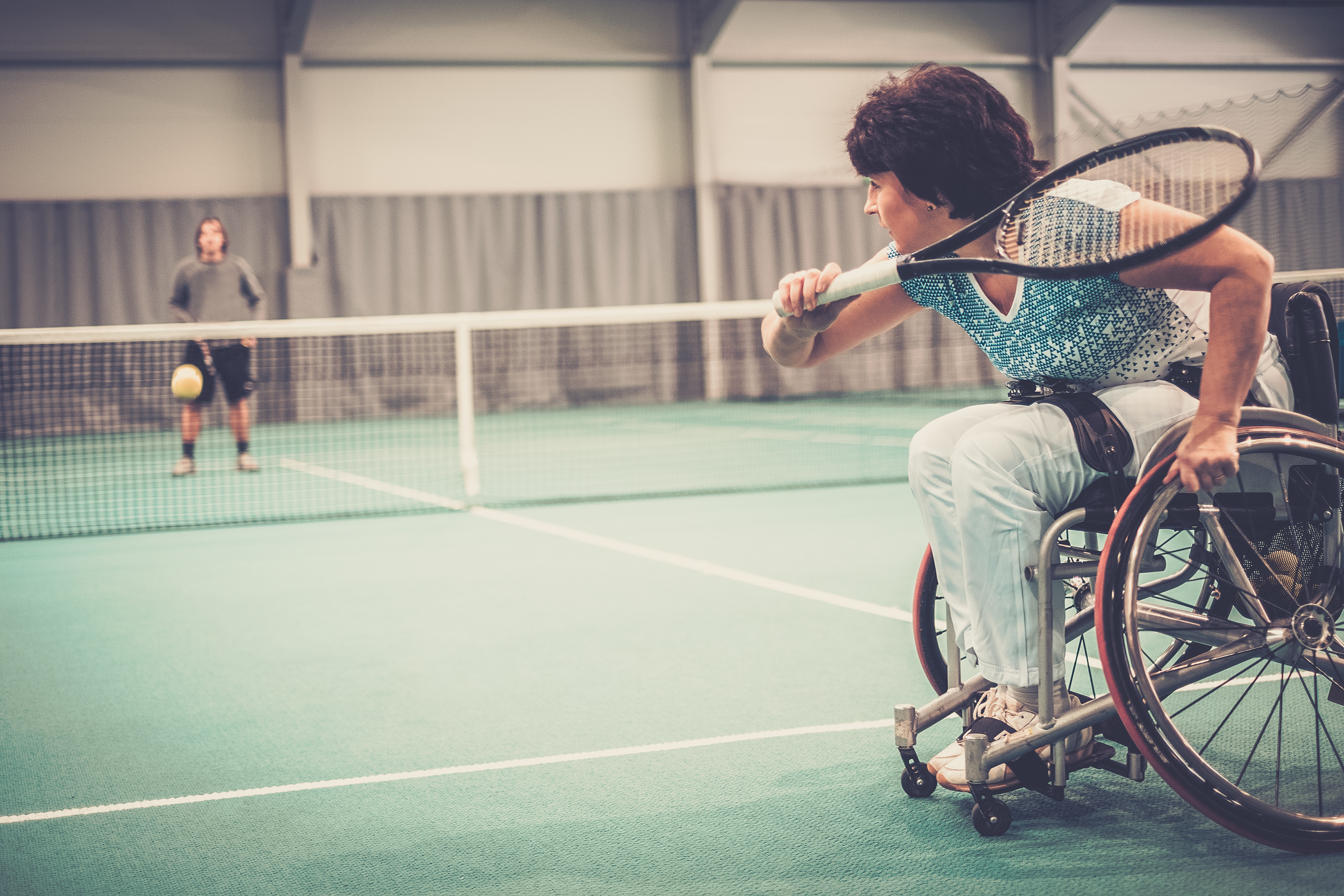Lady in wheelchair playing tennis